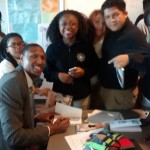 Sadiq signing books for the Honors Students at Digital Harbor